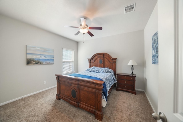 carpeted bedroom with visible vents, ceiling fan, and baseboards