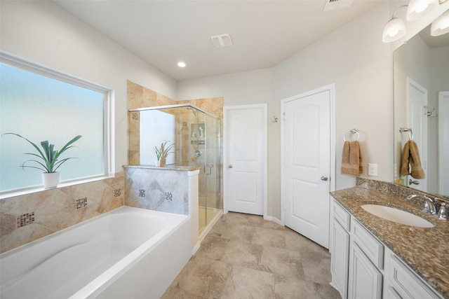 full bathroom featuring vanity, a shower stall, and a bath