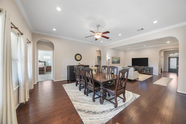 dining room featuring arched walkways, visible vents, recessed lighting, and dark wood-type flooring