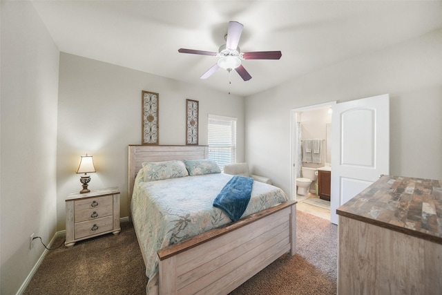 carpeted bedroom featuring ceiling fan, baseboards, and connected bathroom