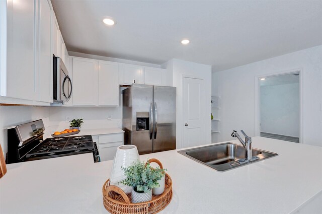 kitchen featuring a sink, white cabinetry, recessed lighting, appliances with stainless steel finishes, and light countertops