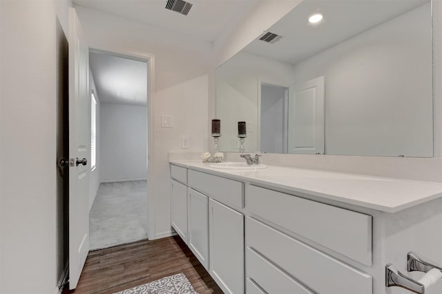 bathroom with recessed lighting, visible vents, wood finished floors, and vanity