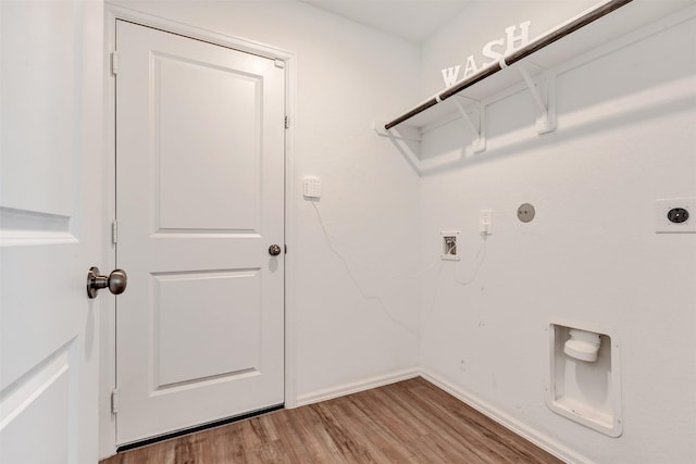 laundry room featuring light wood finished floors, baseboards, laundry area, hookup for a gas dryer, and electric dryer hookup