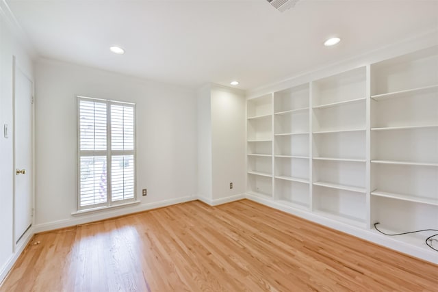 unfurnished room featuring recessed lighting, baseboards, built in shelves, and light wood-style flooring