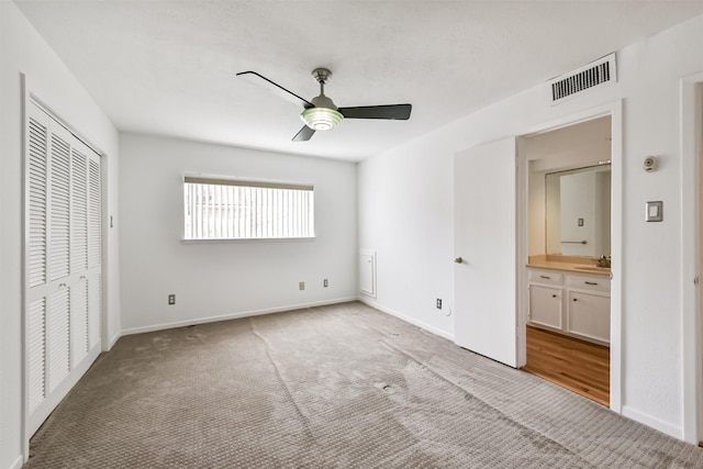 unfurnished bedroom with visible vents, carpet flooring, a ceiling fan, and baseboards