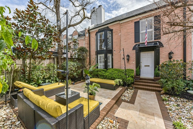 view of patio with an outdoor hangout area, entry steps, and fence