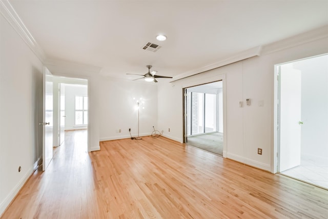 empty room with baseboards, visible vents, ceiling fan, ornamental molding, and light wood-style floors