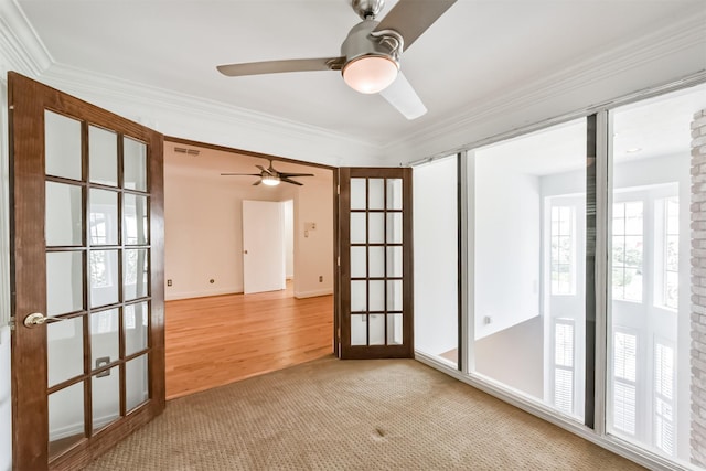 spare room with visible vents, french doors, carpet, and ornamental molding