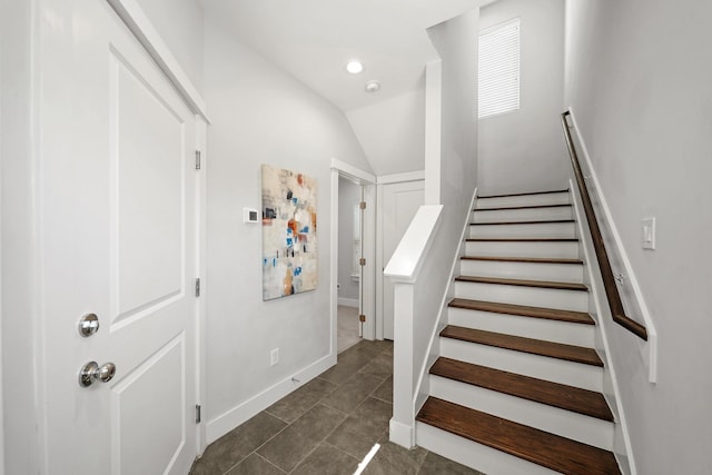 staircase featuring tile patterned floors, recessed lighting, baseboards, and vaulted ceiling