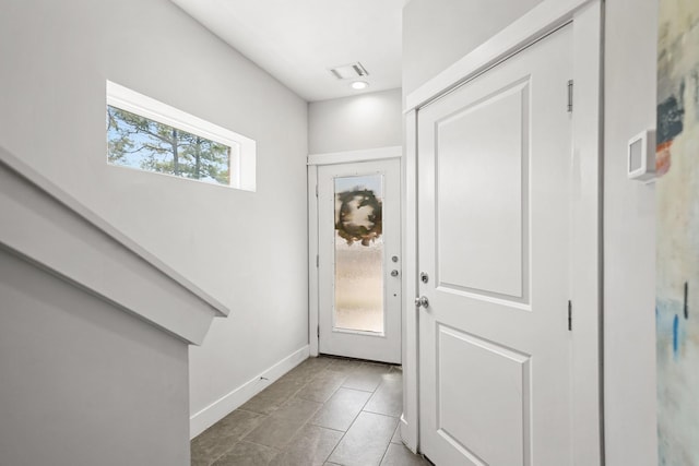 foyer featuring tile patterned flooring, visible vents, and baseboards