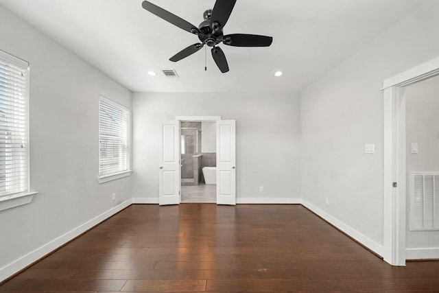 unfurnished bedroom featuring hardwood / wood-style flooring, baseboards, and visible vents