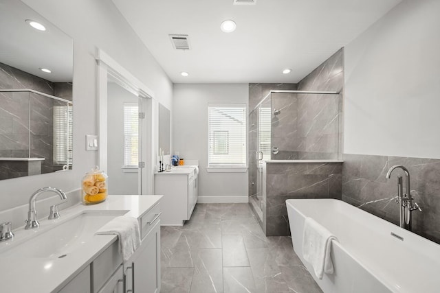 full bathroom featuring visible vents, two vanities, a sink, a shower stall, and marble finish floor