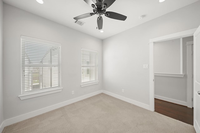 empty room featuring a ceiling fan, baseboards, visible vents, recessed lighting, and carpet flooring