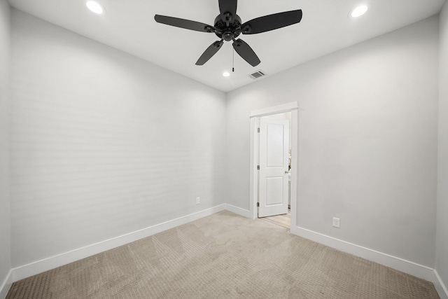 empty room with recessed lighting, visible vents, light carpet, and baseboards