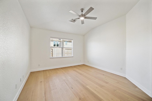 unfurnished room featuring baseboards, ceiling fan, and light wood finished floors