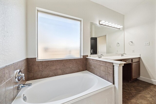 full bathroom with a bath, tile patterned flooring, and vanity