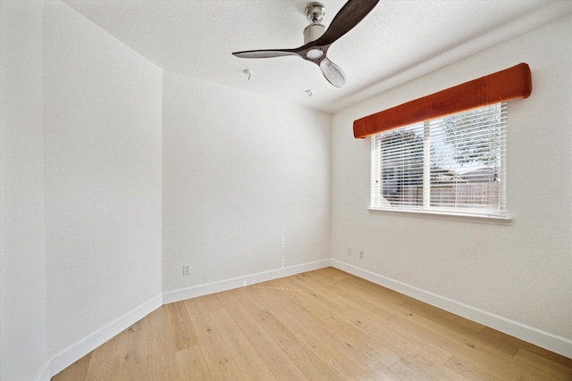 unfurnished room with light wood-type flooring, baseboards, and ceiling fan