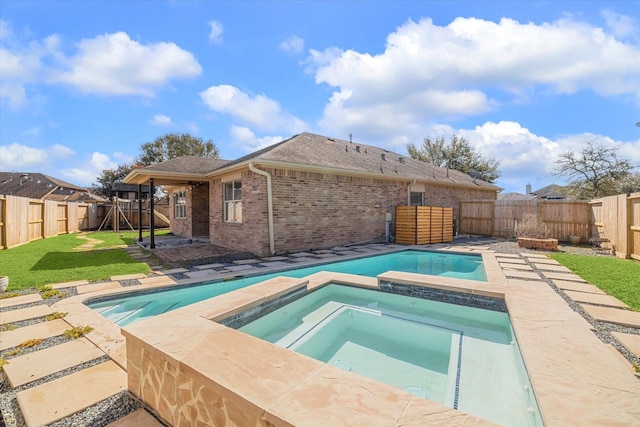 view of pool featuring a fenced backyard, a yard, a fenced in pool, an in ground hot tub, and a patio area