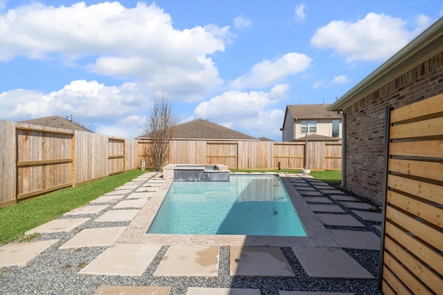 view of pool featuring a patio, a fenced backyard, and a pool with connected hot tub