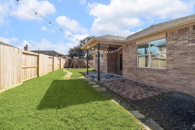 view of yard with a patio area, a fenced backyard, and ceiling fan