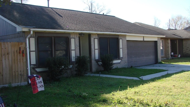 ranch-style house featuring a front lawn, concrete driveway, an attached garage, a shingled roof, and brick siding