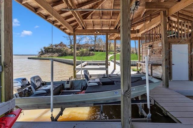 dock area with boat lift and a water view