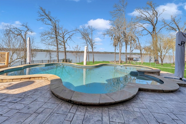 view of swimming pool with a pool with connected hot tub, a patio, and a water view