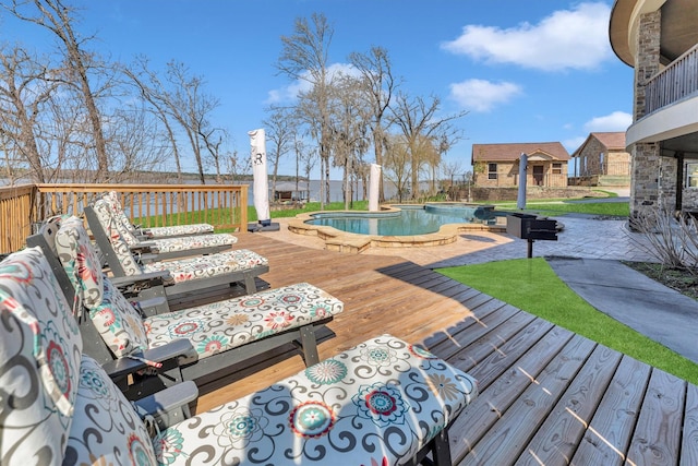 deck with a fenced in pool, a jacuzzi, and an outdoor structure