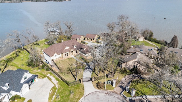 drone / aerial view featuring a residential view and a water view