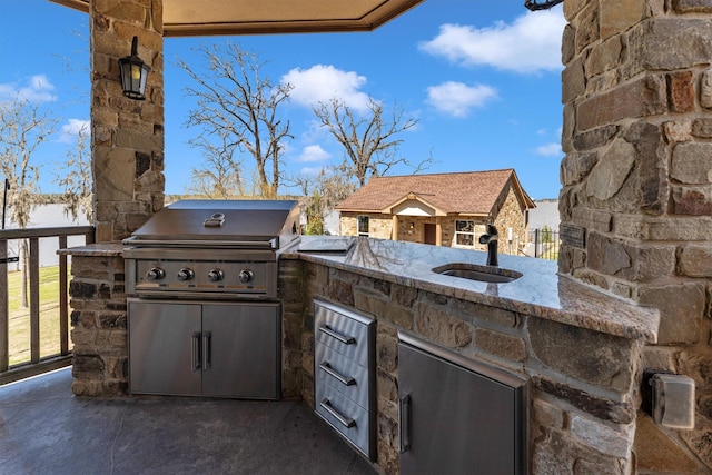 view of patio / terrace with area for grilling, a grill, and a sink