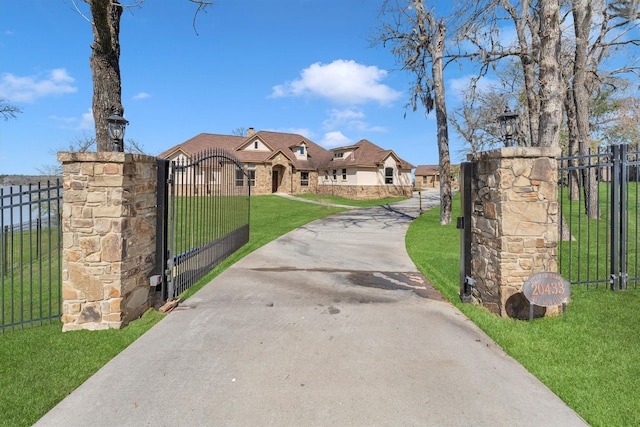 view of front of home with a front yard, a gate, and fence