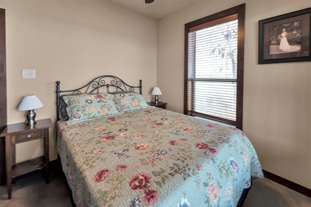 bedroom featuring multiple windows, baseboards, and a ceiling fan