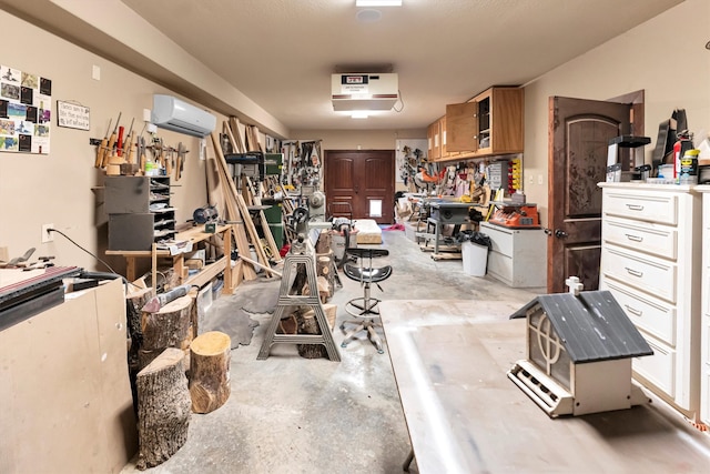 garage with a workshop area and a wall unit AC