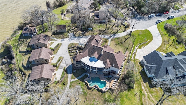 drone / aerial view featuring a residential view and a water view