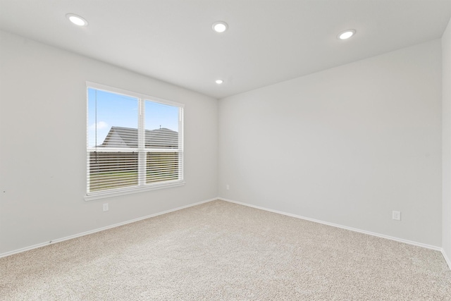 empty room with recessed lighting and baseboards