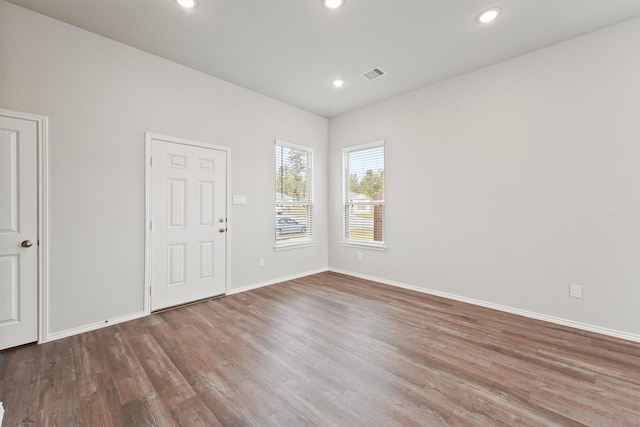 unfurnished room with visible vents, recessed lighting, baseboards, and wood finished floors