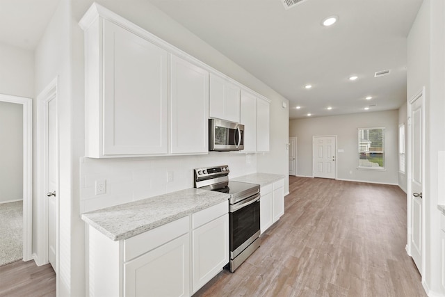 kitchen featuring light wood-type flooring, visible vents, white cabinetry, recessed lighting, and stainless steel appliances