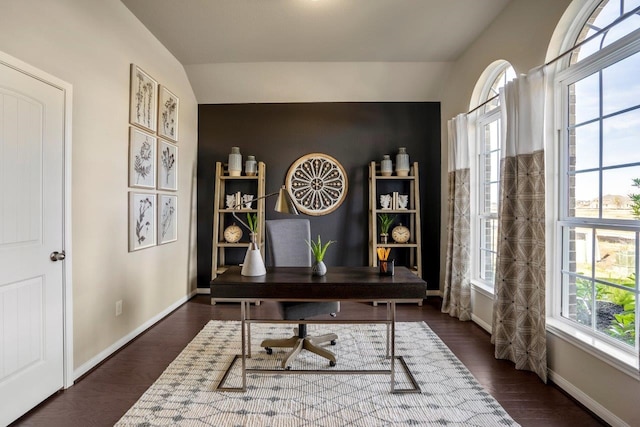 office space featuring a wealth of natural light, baseboards, lofted ceiling, and dark wood finished floors