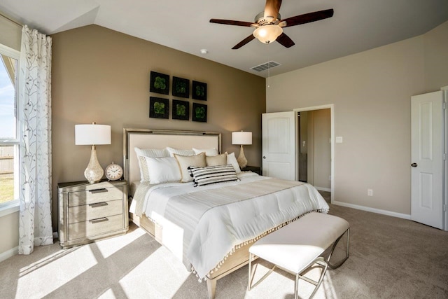 carpeted bedroom with visible vents, lofted ceiling, baseboards, and a ceiling fan