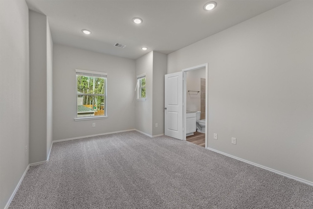 carpeted spare room featuring visible vents, recessed lighting, and baseboards