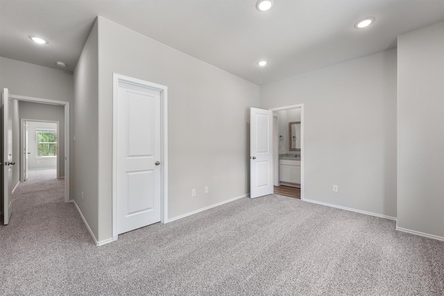 unfurnished bedroom with carpet flooring, recessed lighting, and baseboards