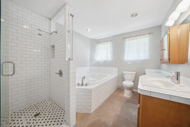 bathroom featuring a shower stall, toilet, vanity, and a garden tub