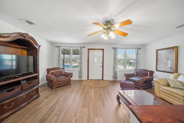 living room with plenty of natural light, light wood-style floors, visible vents, and ceiling fan