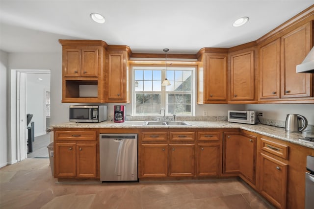 kitchen with brown cabinets, appliances with stainless steel finishes, and a sink