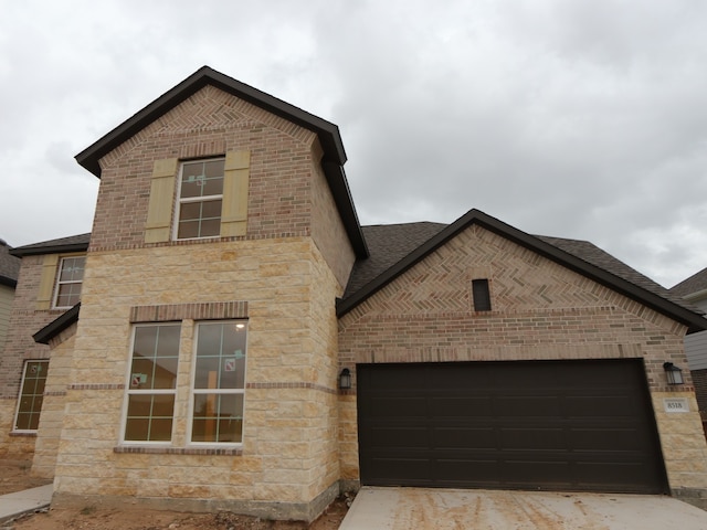 8518 Pier Cove Dr, Cypress, TX 77433 - french provincial home featuring brick siding, stone siding, a garage, and a shingled roof