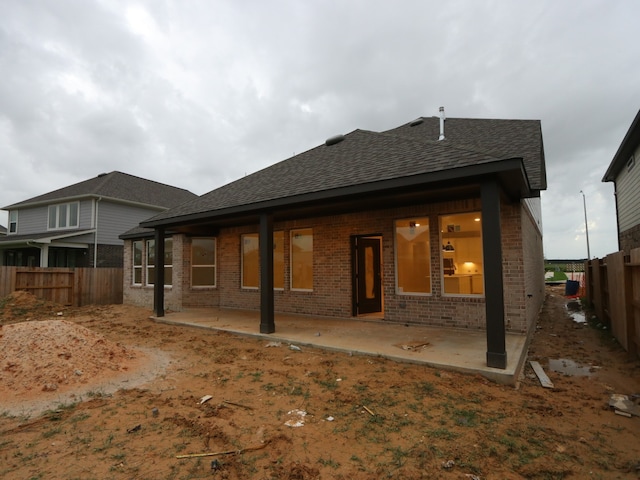 8518 Pier Cove Dr, Cypress, TX 77433 - back of house with brick siding, a shingled roof, a fenced backyard, and a patio area