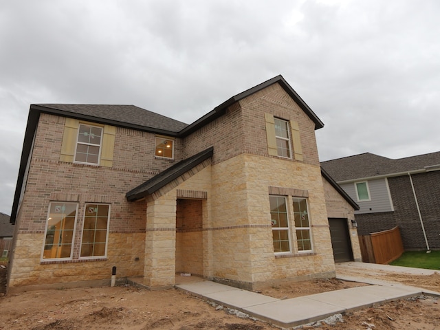 8518 Pier Cove Dr, Cypress, TX 77433 - view of front facade with brick siding, stone siding, an attached garage, and roof with shingles