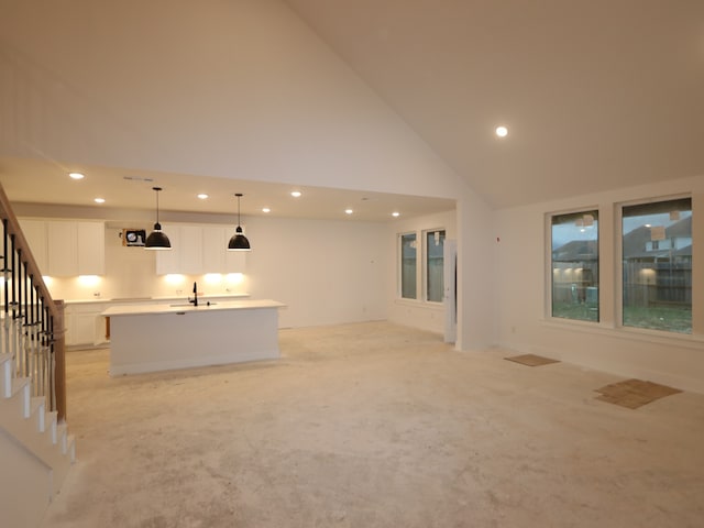 8518 Pier Cove Dr, Cypress, TX 77433 - unfurnished living room featuring recessed lighting, stairway, high vaulted ceiling, and light colored carpet
