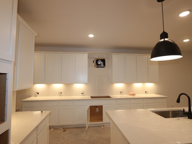 8518 Pier Cove Dr, Cypress, TX 77433 - kitchen with white cabinets, decorative light fixtures, light countertops, and recessed lighting