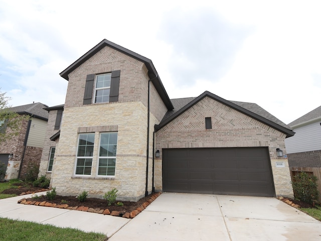 8518 Pier Cove Dr, Cypress, TX 77433 - view of front of home with driveway, brick siding, an attached garage, and stone siding